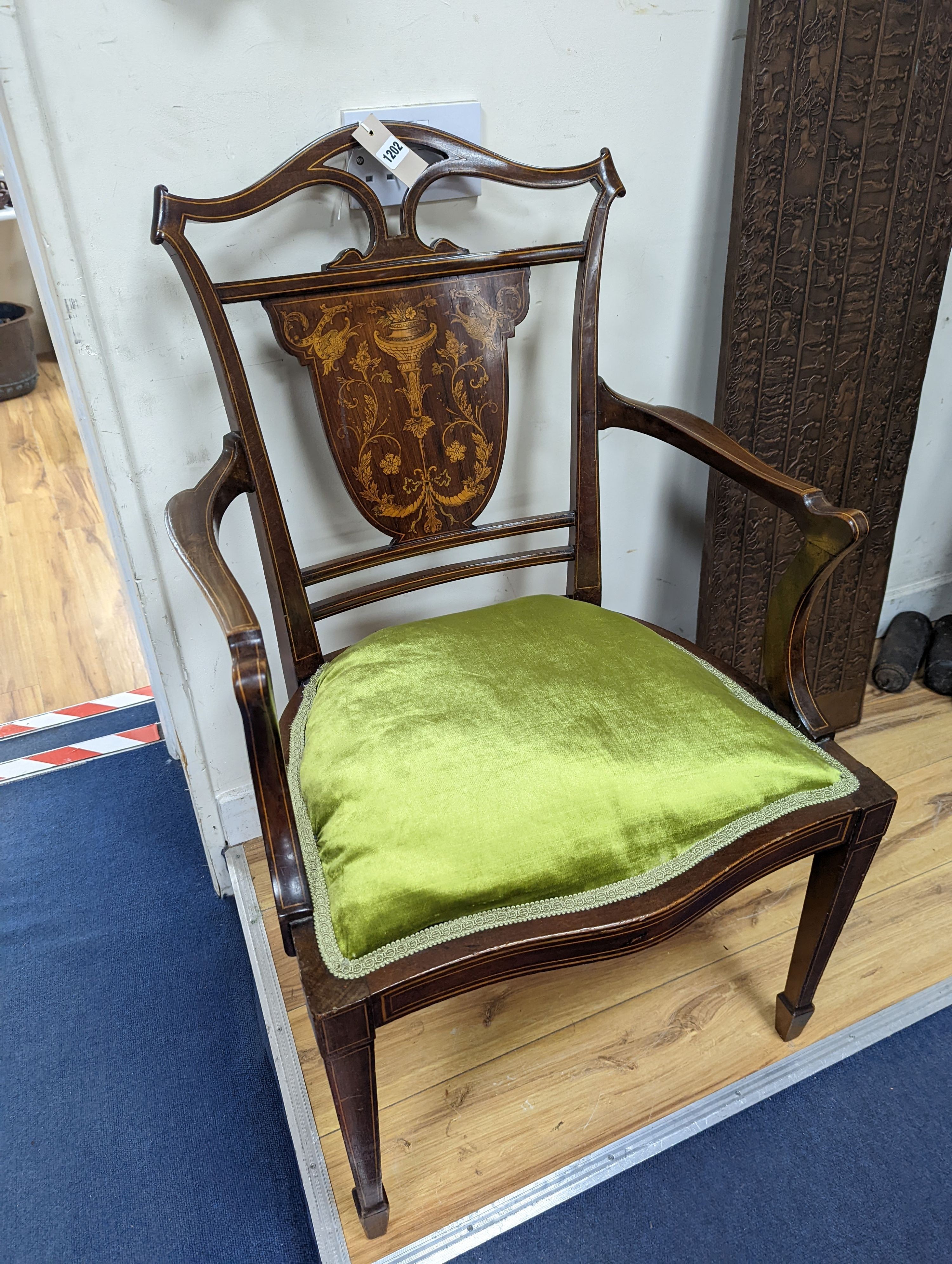 An Edwardian marquetry inlaid mahogany elbow chair